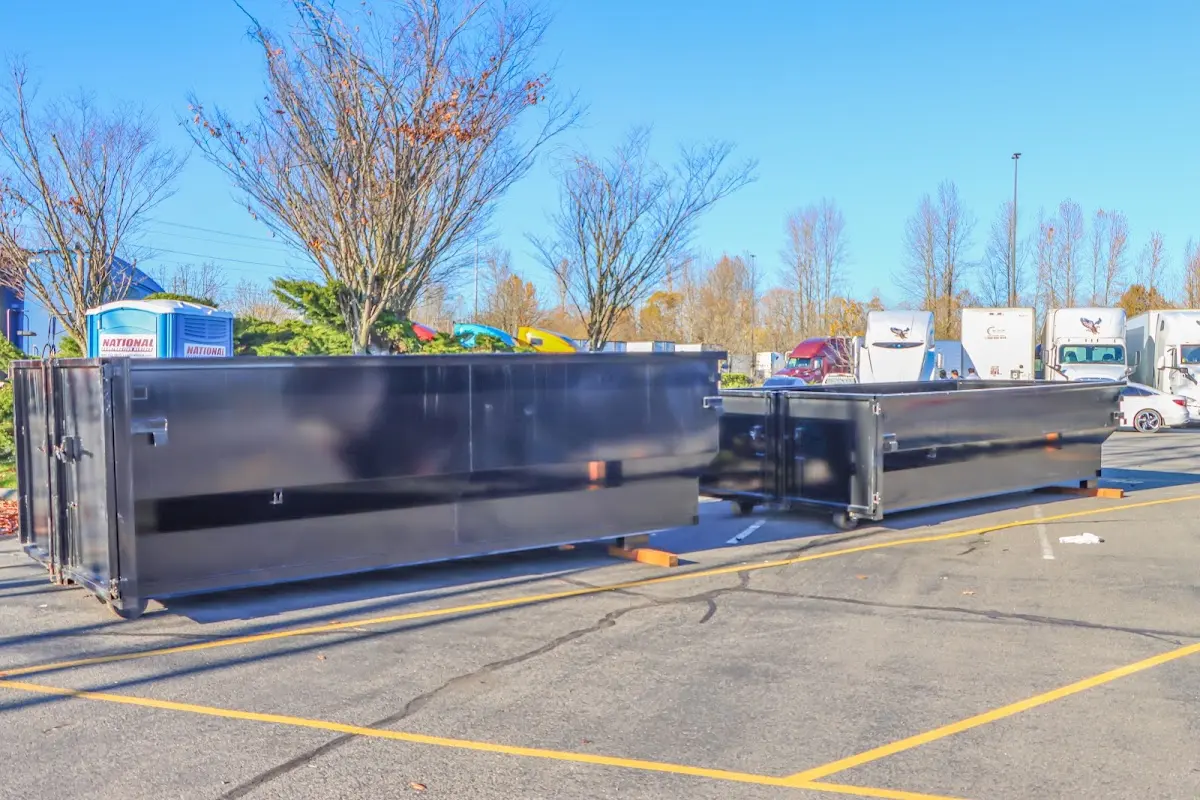 Professional dumpster rental service with roll-off container on residential driveway in Fairborn